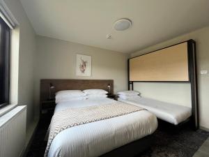 Postel nebo postele na pokoji v ubytování Swagman Chalet