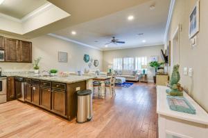 an open kitchen and living room with a table at Miramar Beach Condo with Pool - Walk to Beach! in Destin