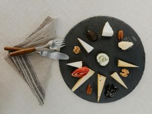 a plate with a fork and cheese on it at Chalet in Montafon with Private Sauna & Views in Vandans +26 photos