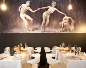 a painting of two dancers on the wall of a restaurant at Funchal Design Hotel in Funchal