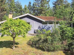a small house in a yard with a tree at 6 person holiday home in Højslev-By Traum in Højslev