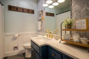 a bathroom with a sink and a toilet and a mirror at Taylors Gem for Families - Charming Family Getaway in Taylors