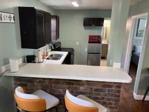 a kitchen with a counter and two stools at Chillpad Blocks from FrenchQuarters in New Orleans