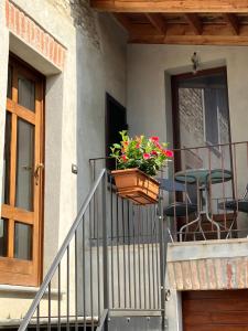 een balkon met een pot bloemen op een huis bij UN PASSO DAL CASTELLO in Barolo