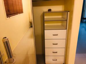 a closet with a stack of drawers and a fan at Aspley property in Brisbane