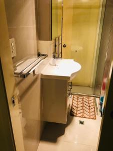 a bathroom with a white sink and a shower at Aspley property in Brisbane