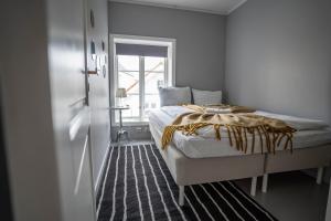 a bedroom with a bed and a window at In Heart of Stavanger BnB with Billiard & Sauna in Stavanger