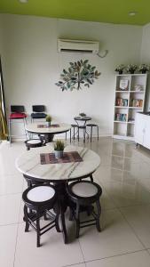 a group of tables and stools in a room at Olive Hotel in Johor Bahru