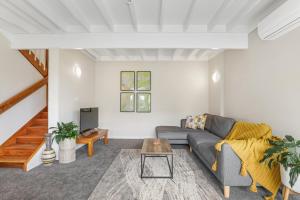 a living room with a couch and a table at Papawai Townhouse #11 in Rotorua