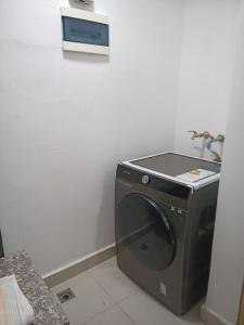 a washing machine in a corner of a room at Simply the most comfortable place next to Boca Chica beach in Boca Chica