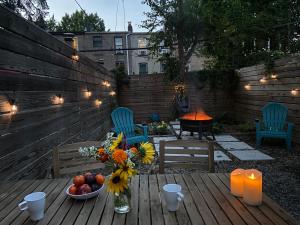a wooden table with a vase of flowers and candles at Perfectly Located Modern 2BR w Priv Backyard in Brooklyn