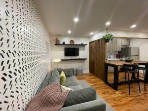 a living room with a couch and a table and a kitchen at Perfectly Located Modern 2BR w Priv Backyard in Brooklyn