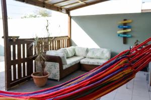 a hammock in a living room with a couch and a couch at Casa Grosso in Willemstad