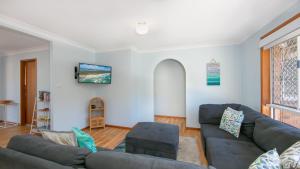 a living room with a couch and a table at Waratah in Iluka