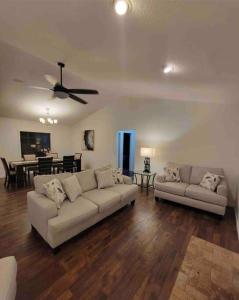 a living room with two couches and a dining room at Florida Oasis in Auburndale