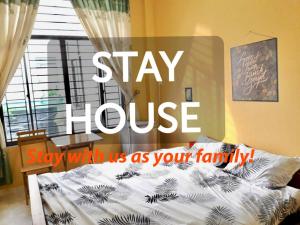 a sign that says stay house say with us as your family at Stay House in Can Tho