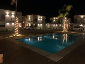 a swimming pool in front of a house at night at Vista24uy Ref1002 in Maldonado
