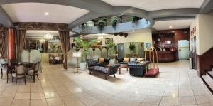 a lobby with couches and chairs in a store at Faraona Grand Hotel in Lima