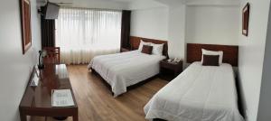 Postel nebo postele na pokoji v ubytování Faraona Grand Hotel