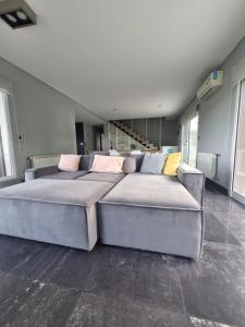 a bedroom with a large bed and a couch at Casa sierra de los padres in Sierra de los Padres +18 photos