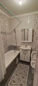 a bathroom with a tub and a toilet and a sink at 2 комнатная квартира 4 in Almaty