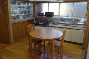 a kitchen with a table and chairs and a sink at ちびっこ・わんこ・リゾート　Ｓａｒａｒｉ　（里楽里） in Tabuchi +55 photos