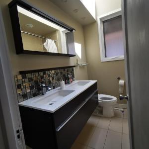 a bathroom with a sink and a toilet at A bright and tidy room in midtown near subway in Toronto