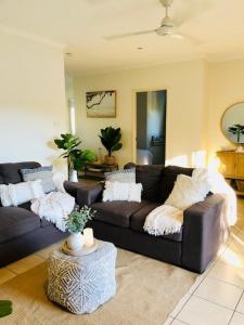 uma sala de estar com um sofá e uma mesa em Trinity Beach Sea Breeze 3 Bedroom Apartment em Trinity Beach