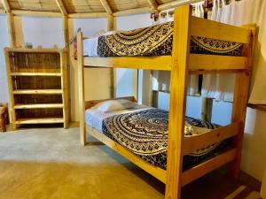 a bedroom with two bunk beds in a room at Waltako Beach Culture in Canoas de Punta Sal