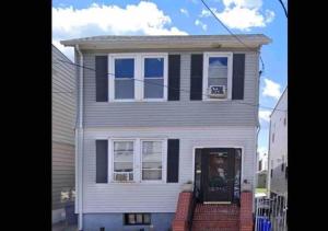 a white and black house with a door at NYC — Newark Airport with Office! in Newark