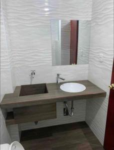 a bathroom with a sink and a mirror at Departamentos en centro histórico 1 in Ayacucho