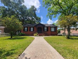 a brick house with a sidewalk in front of a yard at Chickasaw Landing in Chickasaw