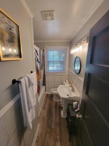 a small bathroom with a sink and a toilet at Chickasaw Landing in Chickasaw +17 photos