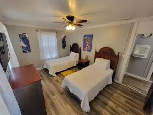 a bedroom with two beds and a ceiling fan at Chickasaw Landing in Chickasaw