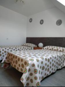 a bedroom with a bed with a polka dot blanket on it at El pisin de Claudia in Colombres