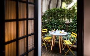 una mesa y sillas frente a un patio en The Poppy Georgetown Guesthouse and Gardens, en Washington