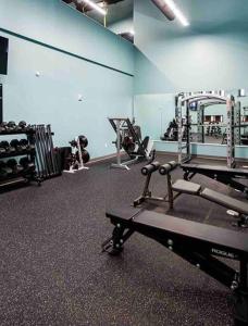 a gym with several tread machines in a room at Beautiful Condo/Rooftop Patio With Free Parking in Cleveland