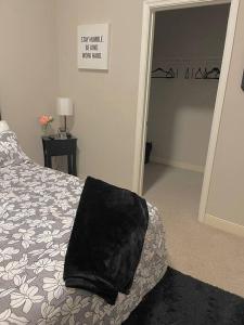 a bedroom with a bed with a black pillow on it at Beautiful Condo/Rooftop Patio With Free Parking in Cleveland