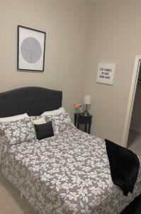 a bedroom with a bed with a comforter and pillows at Beautiful Condo/Rooftop Patio With Free Parking in Cleveland