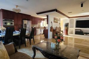 a kitchen and living room with a table with flowers on it at Luxstay in Huntington Beach in Huntington Beach