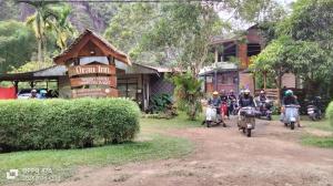 a group of people riding motorcycles in front of a building at Orau Inn in Sarilamak