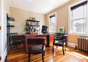 a home office with a desk and two chairs at NYC — Newark Airport with Office! in Newark