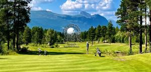 a group of people playing golf on a golf course at Great cabin in Hemsedal wifi golf ski eldorado in Hemsedal