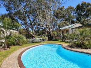 a swimming pool in the yard of a house at Golden Heritage Apartments Beechworth in Beechworth