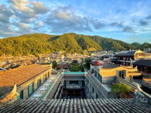 an overhead view of a city with buildings and mountains at Phoenix Hall House Hotel in Fenghuang County