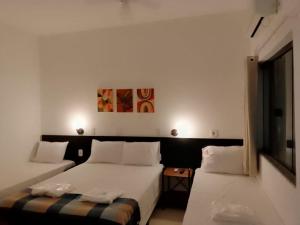 Un pat sau paturi într-o cameră la Hotel Pousada Santa Maria