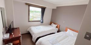 Postel nebo postele na pokoji v ubytování World Business Hotel