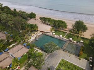 an overhead view of a swimming pool next to a beach at Jimbaran Puri, A Belmond Hotel, Bali in Jimbaran