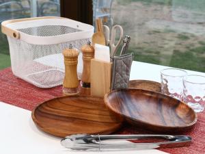 a wooden bowl and other kitchen utensils on a table at Hotel & Glamping ACT FUTTSU in Futtsu