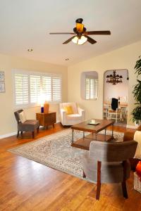 a living room with a couch and a ceiling fan at Cozy Family Hideaway, sleeps 8, 4 tv's yard, shops in Simi Valley